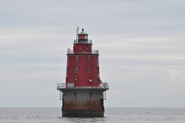 A lighthouse in the Delaware Bay warns travelers of nearby shoals.