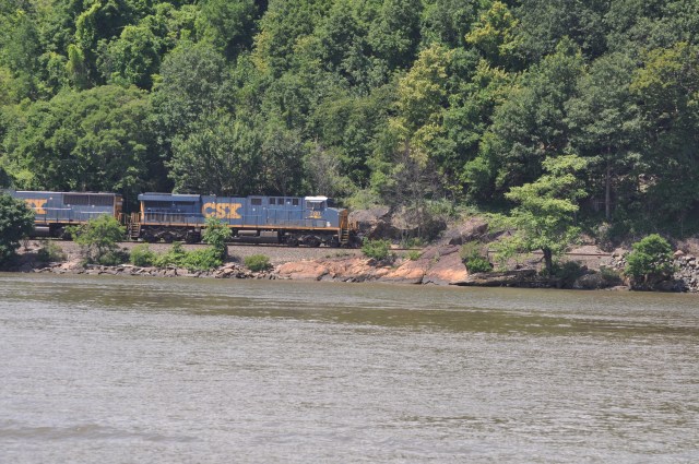 Trains run along the river's edge day and night.