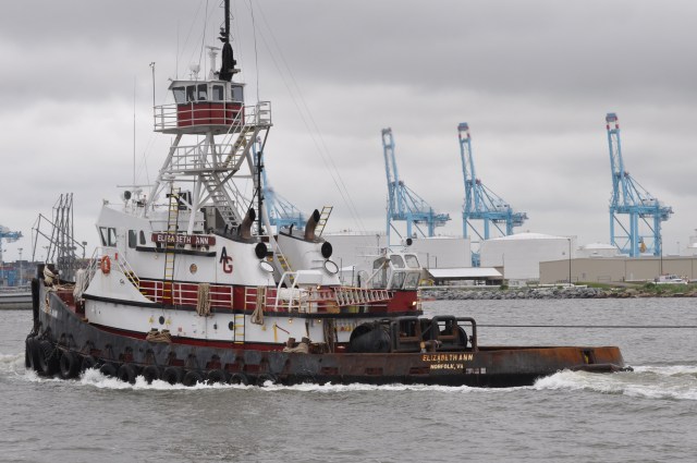 Workboats ply the harbor.