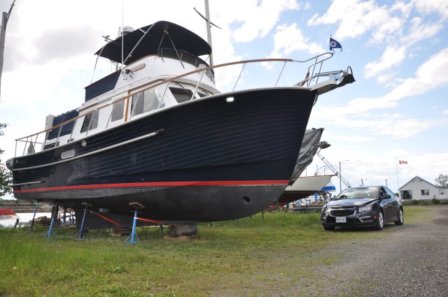 Up on stilts in the yard.  We stayed onboard for two nights, accessing the boat via a ladder to the swim platform.